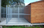 Kennel Runs attached to a wooden outbuilding.